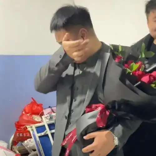 感动男子身穿西装手捧鲜花含泪迎接刨腹产的妻子
